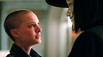 A young white woman talks to a masked person in 