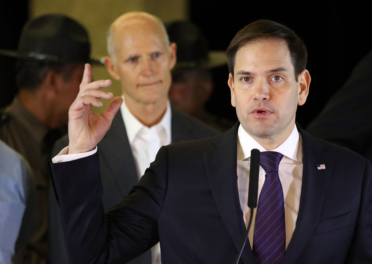 MIAMI, FL - MARCH 15:  Sen. Marco Rubio (R-FL) speaks to the media about a pedestrian bridge near Florida International University's campus that collapsed on March 15, 2018 in Miami, Florida. Florida Governor Rick Scott stands behind him. Reports indicate that there are  four fatalities as a result of the collapse.  (Photo by Joe Raedle/Getty Images)