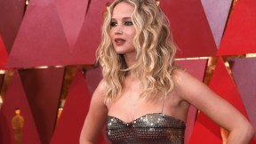 Jennifer Lawrence poses on a red carpet