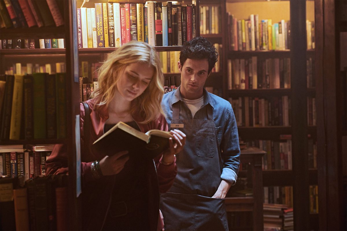 penn badgley as Joe looms behind elizabeth lail as Beck in Netflix's You