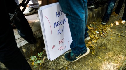 A placard is kept next to an Indian journalist at a protest against sexual harassment in the media industry in New Delhi on October 13, 2018. - India's #MeToo movement has engulfed Bollywood figures, a government minister and several comedians and top journalists. (Photo by CHANDAN KHANNA / AFP) (Photo credit should read CHANDAN KHANNA/AFP/Getty Images)