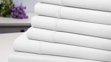 A stack of folded white sheets.