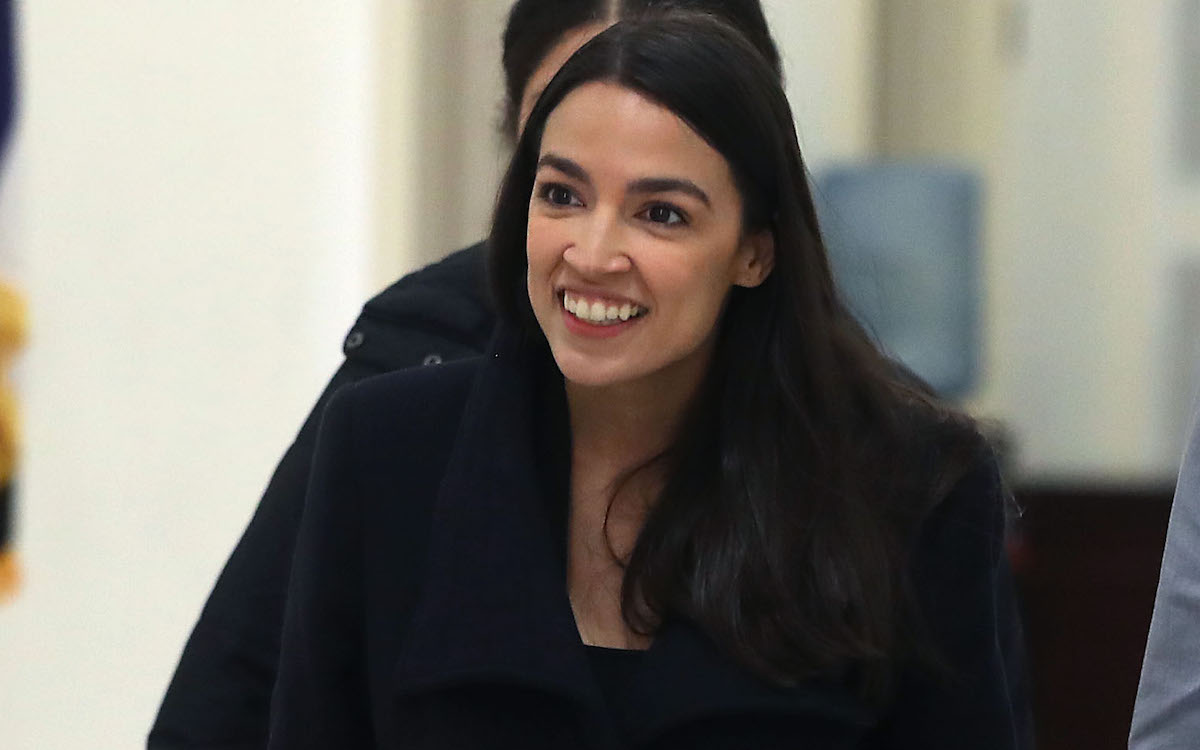 Alexandria Ocasio-Cortez smiling through all of Fox News' BS.