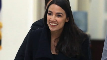 Alexandria Ocasio-Cortez smiling through all of Fox News' BS.