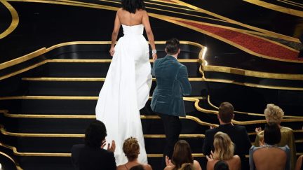 Chris Evans helping Regina King onto the Oscars stage.