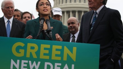 U.S. Rep. Alexandria Ocasio-Cortez (D-NY) speaks as Sen. Ed Markey (D-MA) (R) and other Congressional Democrats listen during a news conference in front of the U.S. Capitol