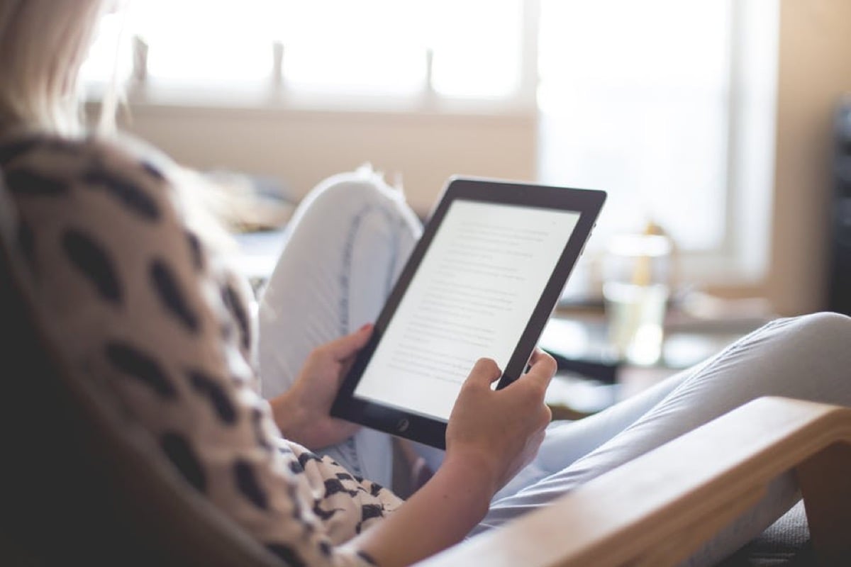 woman looking at tablet