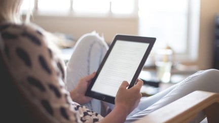 woman looking at tablet