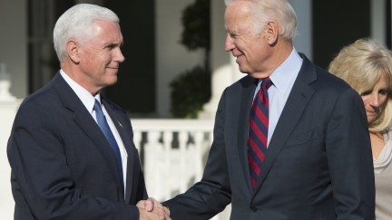 Joe Biden and Mike Pence shake hands.