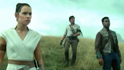 The Star Wars sequel trilogy trio stands on a hill overlooking a destroyed Death Star.