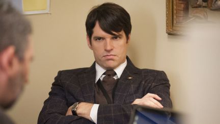 Veep's Jonah Ryan looks angry with arms crossed.