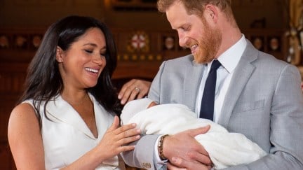 Britain's Prince Harry, Duke of Sussex (R), and his wife Meghan, Duchess of Sussex, pose for a photo with their newborn baby son, Archie Harrison Mountbatten-Windsor, in St George's Hall at Windsor Castle in Windsor, west of London on May 8, 2019. (Photo by Dominic Lipinski / POOL / AFP) (Photo credit should read DOMINIC LIPINSKI/AFP/Getty Images)