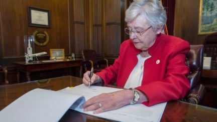 Alabama governor Kay Ivey signs a horrible abortion bill.