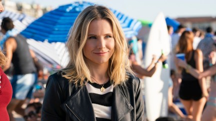 Veronica Mars (Kristen Bell) stands on a crowded beach in a leather jacket.