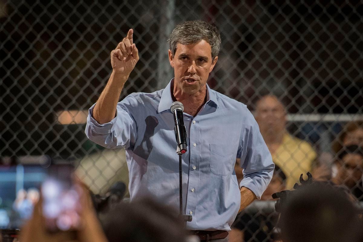 Beto O'Rourke speaks to the crowd during a prayer and candle vigil.