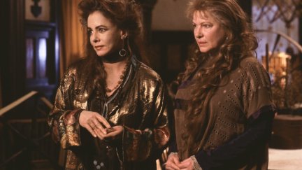 stockard channing and dianne wiest in practical magic, standing in flowing clothing in their house.