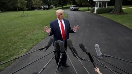 Donald Trump speak to members of the press outside the White House.