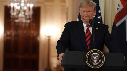 Donald Trump stands at a White House podium.