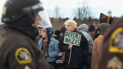 Anti-Nazi protester holds a sign saying 