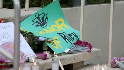 Students lay candles and flowers at the steps of Kennedy Hall to honor the victims of a shooting the day earlier at the University of North Carolina Charlotte, in Charlotte, North Carolina on May 1, 2019. - A 21-year-old student gave his life to save others by tackling a gunman who was shooting up a university classroom, police in the US said May 1, 2019. Charlotte-Mecklenburg Police Chief Kerr Putney said the authorities were still trying to find a motive for Tuesday's attack at the University of North Carolina, which left undergraduate Riley Howell and another student dead. (Photo by Logan Cyrus / AFP) (Photo credit should read LOGAN CYRUS/AFP via Getty Images)