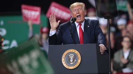 Trump yells from the stage at a rally.