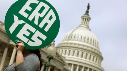 WASHINGTON, DC - MARCH 22: A woman hold up a sign as members of Congress and representatives of women's groups hold a rally to mark the 40th anniversary of congressional passage of the Equal Rights Amendment (ERA) outside the U.S. Capitol March 22, 2012 in Washington, DC. Rep. Carolyn Maloney (D-NY) and Sen. Robert Menendez (D-NJ) introduced a new version of the Equal Rights Amendment last year and called for it to be passed again. (Photo by Chip Somodevilla/Getty Images)