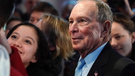 Mike Bloomberg takes a selfie after speaking to supporters at a rally