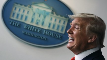 Donald Trump speaks emphatically in front of the white house seal.