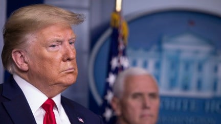 Donald Trump looks sad in front of Mike Pence and the White House seal.