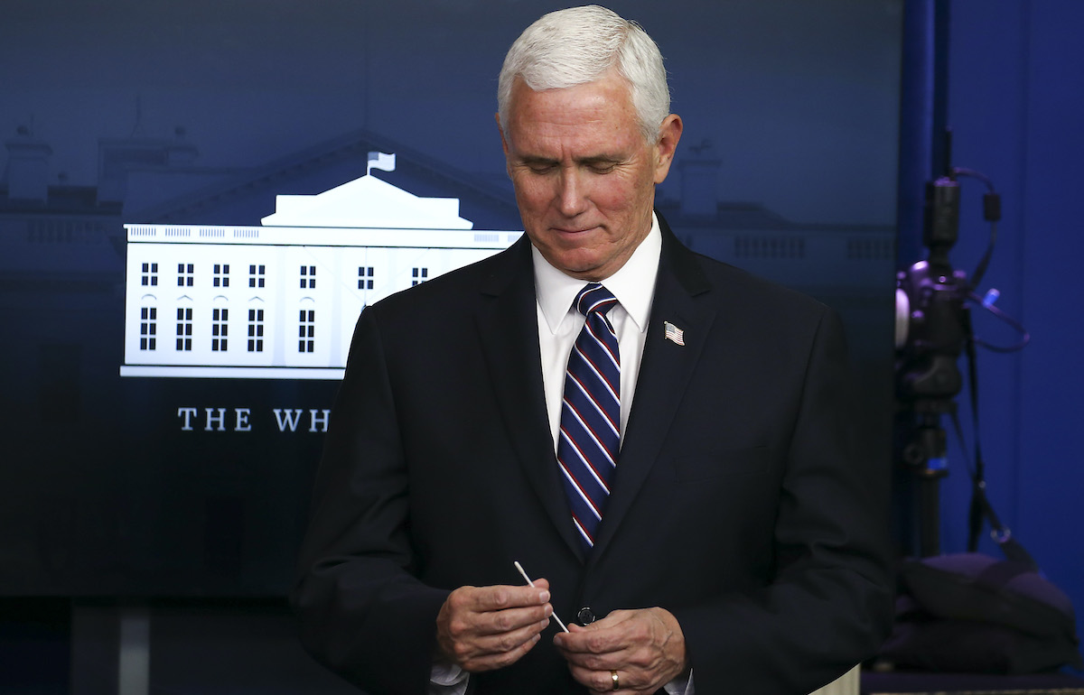 Mike Pence holds up a swab at the daily coronavirus briefing at the White House