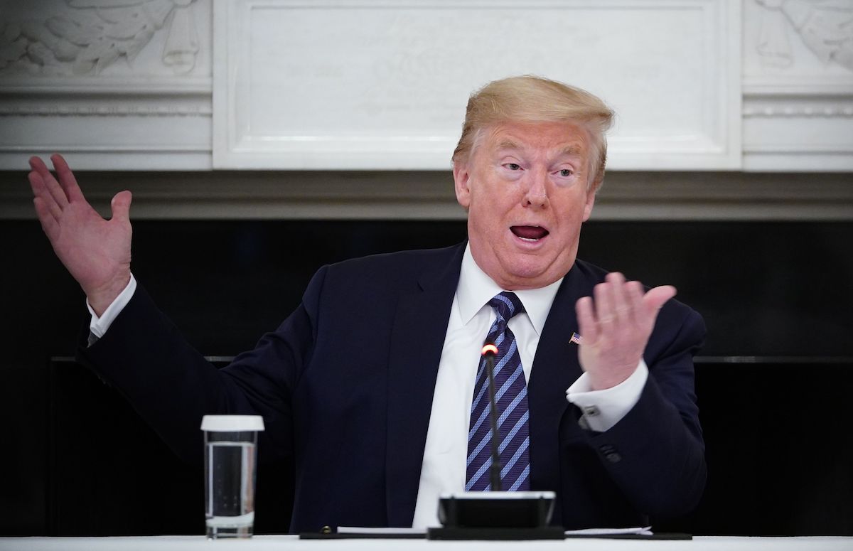 Donald Trump gestures wildly during a meeting.