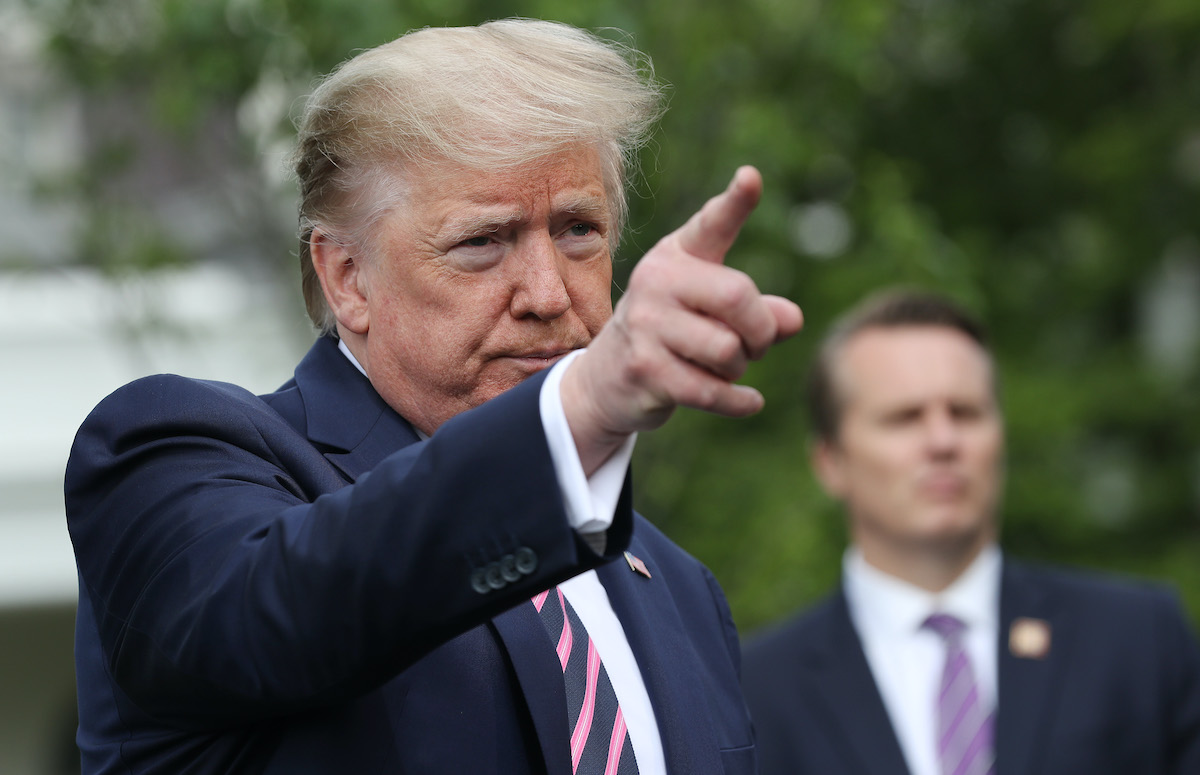 Donald Trump talks to journalists as he departs the White House