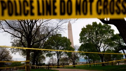 TOPSHOT - Police tape blocks a path leading to the Washington Monument on March 31, 2020, in Washington, DC. - To prevent the spread of coronavirus, COVID-19, , Virginia, Maryland and Washington, DC, all announced March 30 stay-at-home orders, which strongly discourage residents from leaving home, except for essential trips like grocery or pharmacy shopping, or to travel for work. (Photo by ANDREW CABALLERO-REYNOLDS / AFP) (Photo by ANDREW CABALLERO-REYNOLDS/AFP via Getty Images)