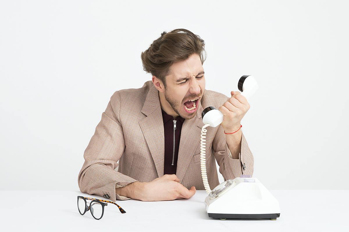 man yelling into phone