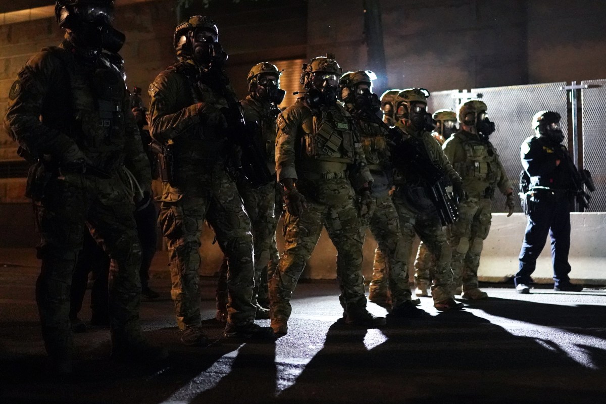 PORTLAND, OR - JULY 30: Federal officers form a police line in front of the Mark O. Hatfield U.S. Courthouse in the early hours of July 30, 2020 in Portland, Oregon. Protests against the federal presence in Portland continued Wednesday following an announcement by Governor Kate Brown that federal officers would begin a phased withdrawal from the city. (Photo by Nathan Howard/Getty Images)