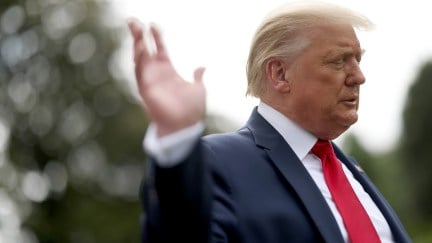 Donald Trump waves while departing the White House