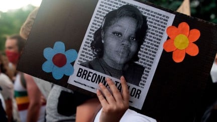 A demonstrator holds a sign with the image of Breonna Taylor, a black woman who was fatally shot by Louisville Metro Police Department officers, during a protest against the death George Floyd in Minneapolis, in Denver, Colorado on June 3, 2020. - US protesters welcomed new charges brought Wednesday against Minneapolis officers in the killing of African American man George Floyd -- but thousands still marched in cities across the country for a ninth straight night, chanting against racism and police brutality. (Photo by Jason Connolly / AFP) (Photo by JASON CONNOLLY/AFP via Getty Images)