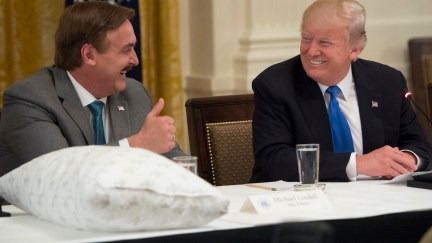 Donald Trump speaks alongside Mike Lindell (L), founder of My Pillow