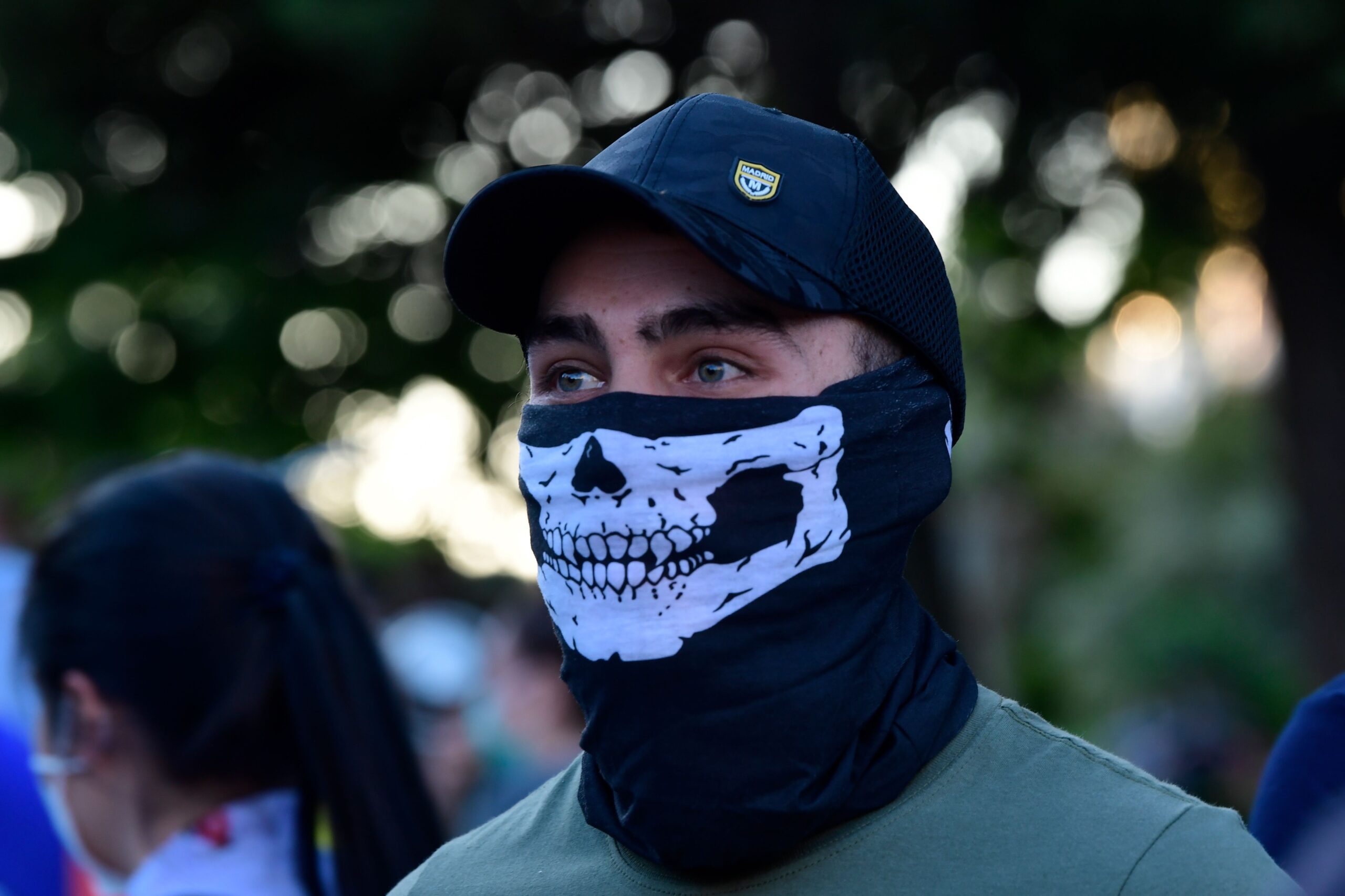 A demonstrator covers his face with a neck gaiter as he takes part in a demonstration against the government's handling of the coronavirus crisis, on May 20, 2020, in Alcorcon, near Madrid. - Spain's prime minister won parliamentary backing extend the lockdown for another two weeks today, despite opposition from his rightwing opponents and protests against his minority coalition government. It was the fifth time the state of emergency has been renewed, meaning the restrictions will remain in force until June 6 in a measure passed by 177 votes in favour, 162 against and 11 abstentions. (Photo by JAVIER SORIANO / AFP) (Photo by JAVIER SORIANO/AFP via Getty Images)