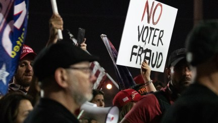 A no voter fraud sign is displayed by a protester in support of President Donald Trump at the Maricopa County Elections Department off