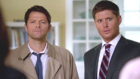 Castiel and Dean stand next to each other in The CW's Supernatural.