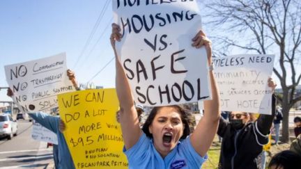 Residents and business owners protest Candlewood Suites being transformed into housing for homeless.