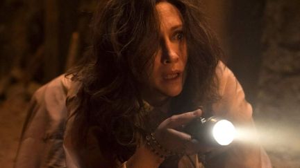 A woman holding a flashlight in The Conjuring: The Devil Made Me Do It