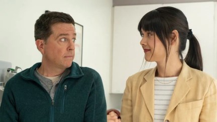 Patti Harrison and Ed Helms pull faces at each other in Together Together.