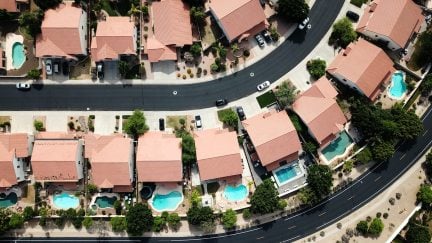 Aerial shot of a housing subdivision with tons of pools in backyards