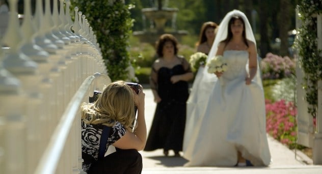 A picture of a photographer photographing a bride