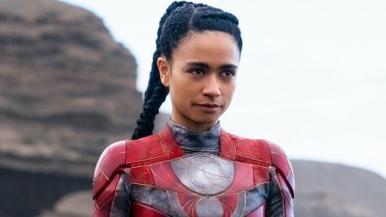 Actor Lauren Ridloff strikes a pose as Makkari in a red supersuit in 'Eternals'