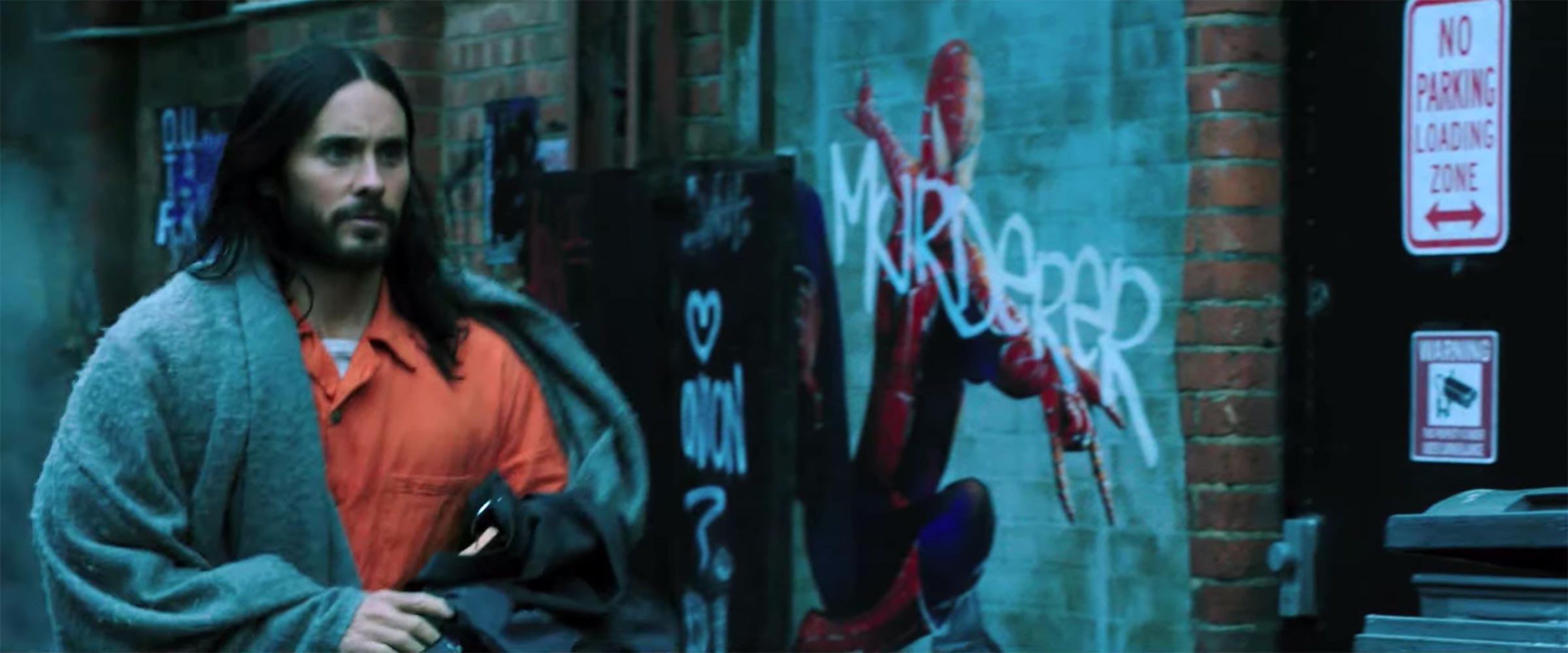 Jared Leto as Morbius walking by a Spider-Man graffiti