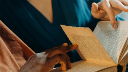 Two people looking at a book closely. (Image: Cottonbro via Pexels.) https://www.pexels.com/photo/couple-holding-a-book-6263956/