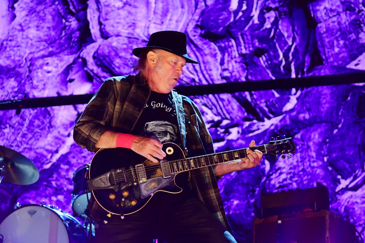 Neil young playing the guitar